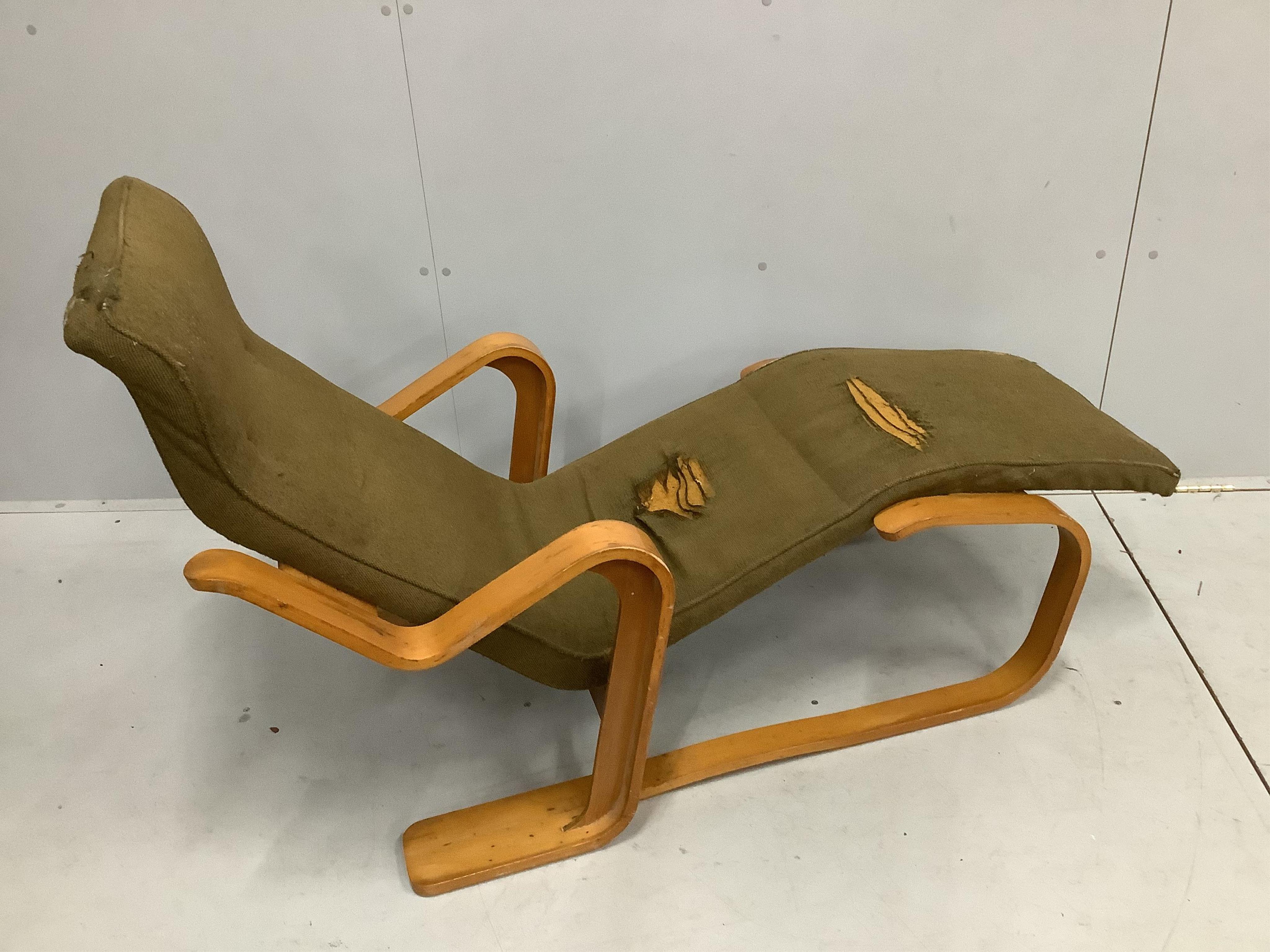 After Marcel Breuer, a bent ply long chair, circa 1960, width 134cm, depth 65cm, height 81cm. Condition - original upholstery now in need of replacement or removal, frame fair